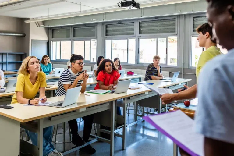 Students sitting in a classroom with laptop