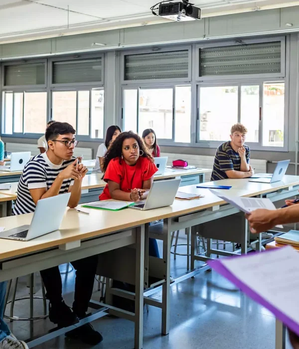 Students sitting in a classroom with laptops